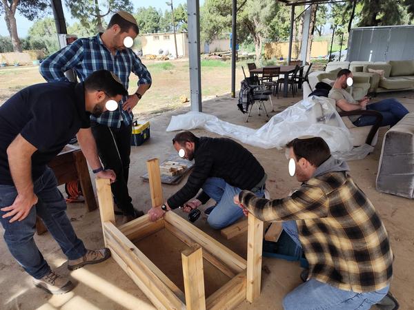 Men building a wooden planter frame outdoors