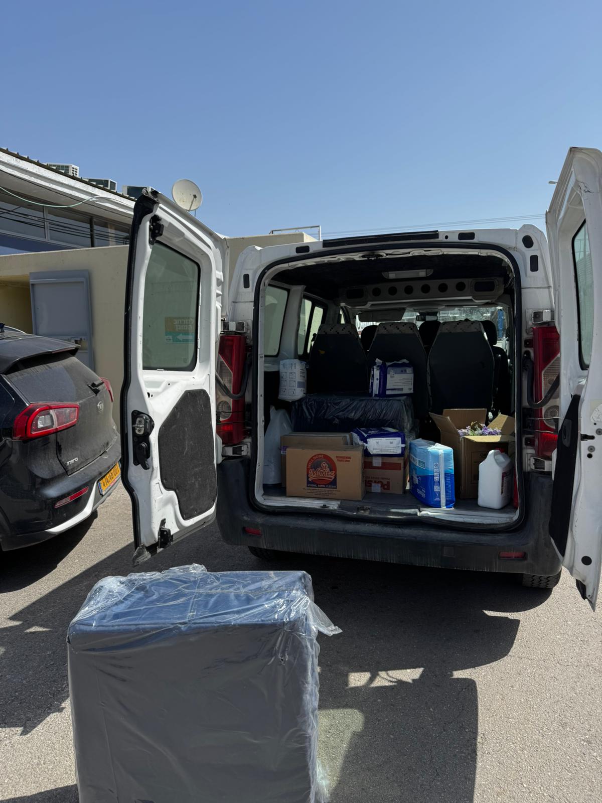 Van loaded with supply boxes ready for distribution
