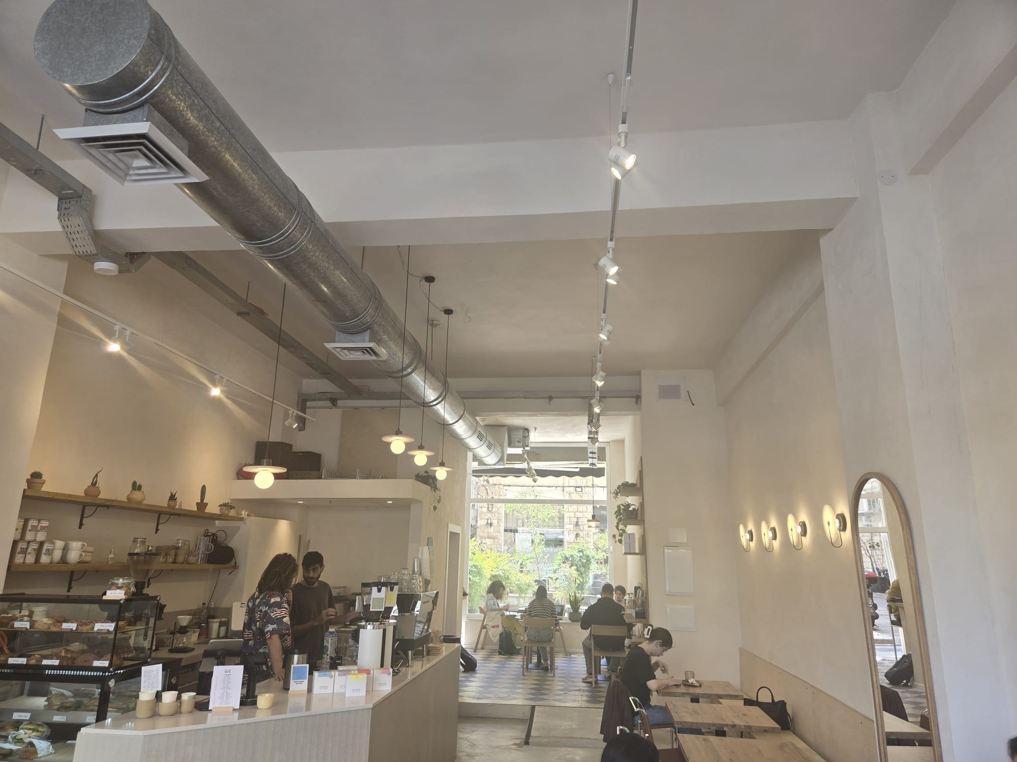 Full interior view of Cafe Maagan with guests and the service counter