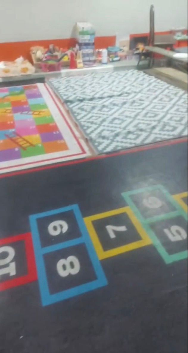 Children's corner set up with mattresses inside a shelter