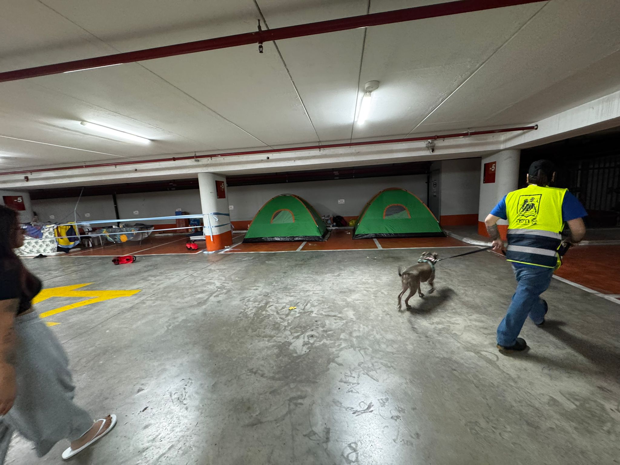 Underground parking shelter with tent pitched inside